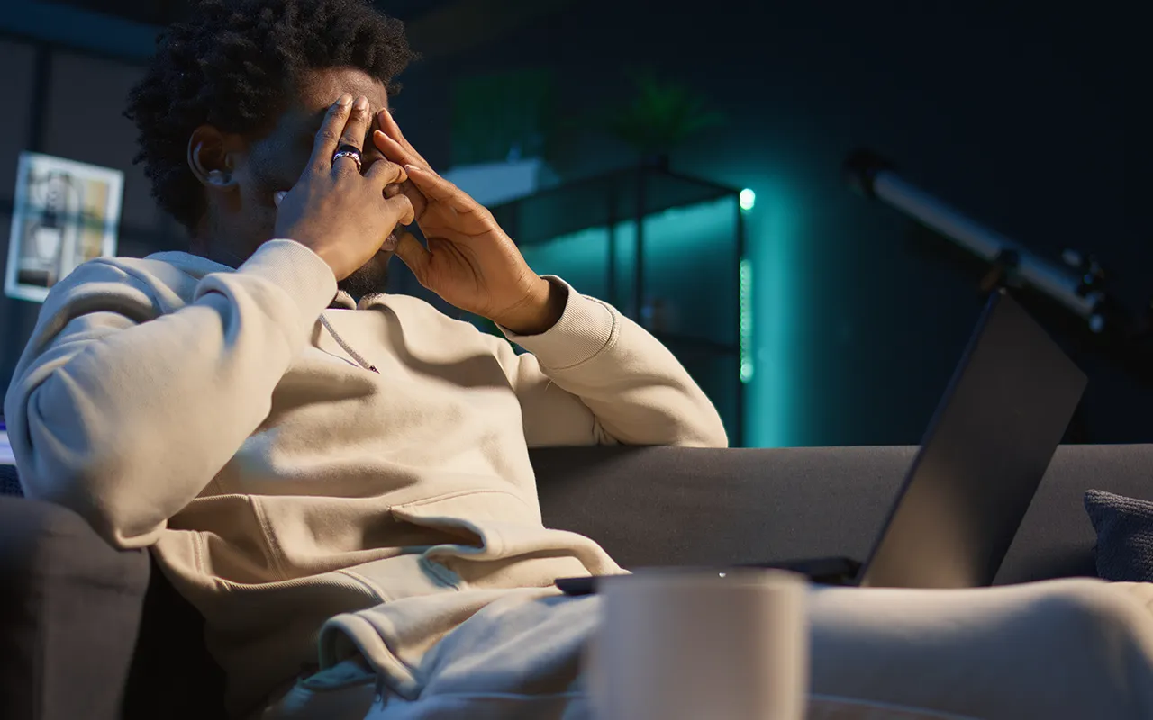 A thoughtful person looking at digital data projections symbolizing the cooling hype of artificial intelligence in 2025 — representing the AI bubble and shifting tech trends.