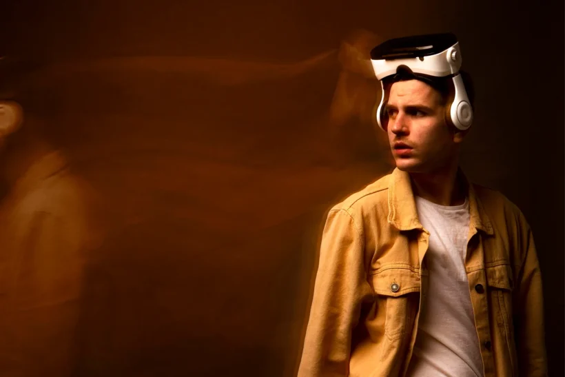 A man wearing a futuristic VR headset looking thoughtful, symbolizing the uncertainty and human reflection surrounding the AI bubble and technology trends in 2025.